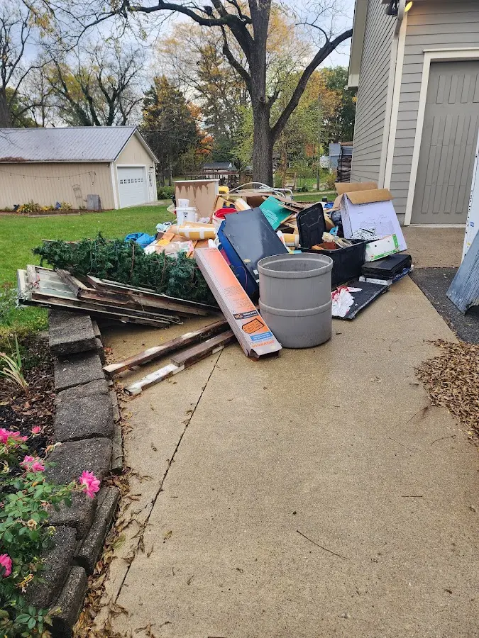 Dumpster being loaded with debris for Estate Cleanout Dumpster Rental in Ashby